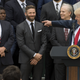 US President Donald Trump speaks alongside New England Patriots head coach Bill Belichick (L) and members of the team during a ceremony honoring them as 2017 Super Bowl Champions on the South Lawn of the White House in Washington, DC, April 19, 2017.